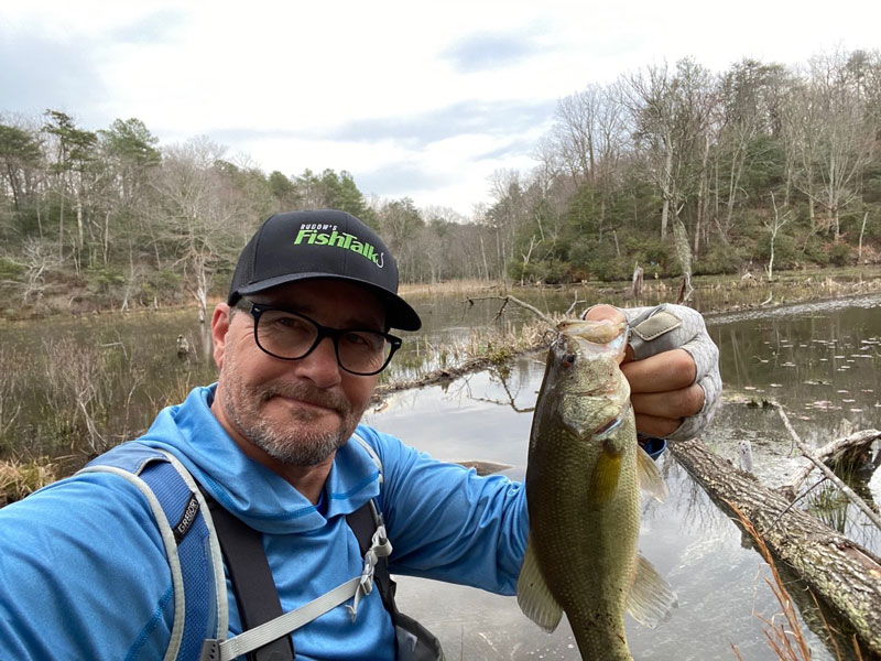 angler catching bass in trees