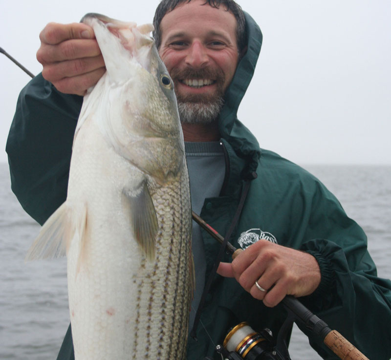 angler holding a rockfish caught by feather jigging