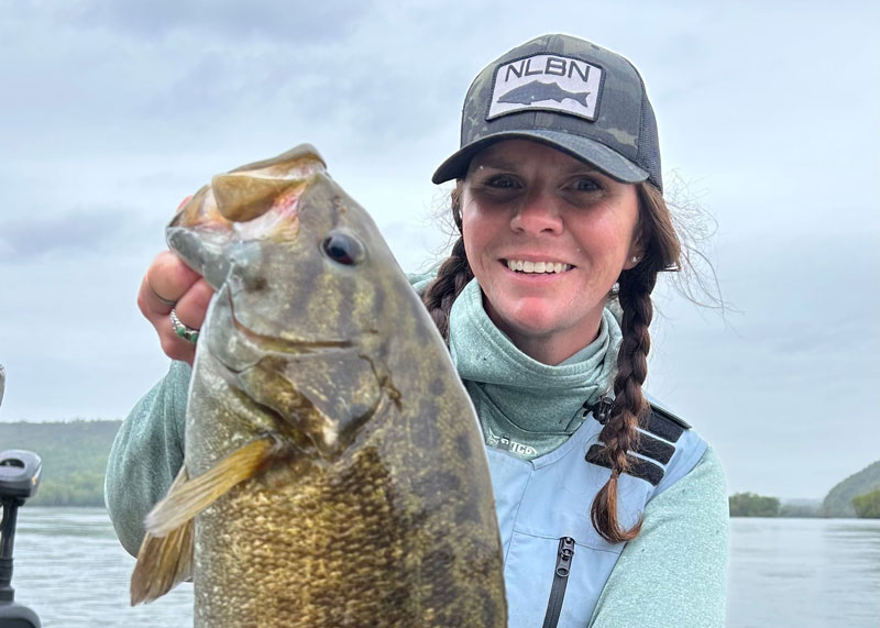 captain kayla halie with a smallmouth bass