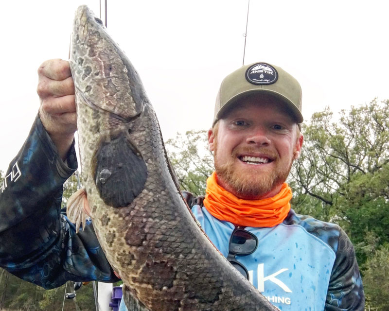 angler with a big snakehead fish