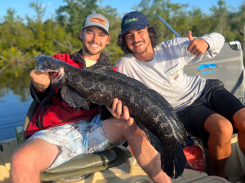 anglers with a snakehead they caught