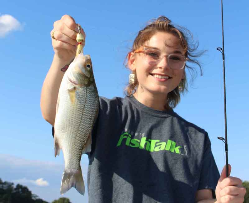 angler holding up a white perch